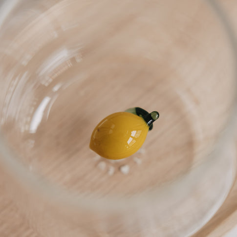 Detailaufnahme Zitronen Motiv im Glas, modernes Trinkglas auf Holztablett