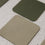 Wendbare Untersetzer in Beige und Grün mit Herzprägung in detailreicher Nahaufnahme