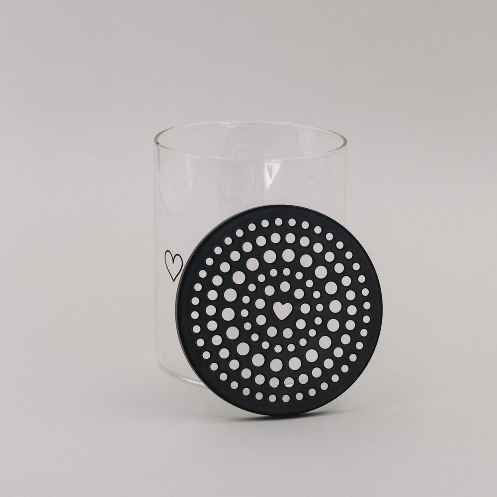 Schwarzer Blumenhalter-Deckel neben Vorratsglas – detailreiche Ansicht mit Herzloch in der Mitte
