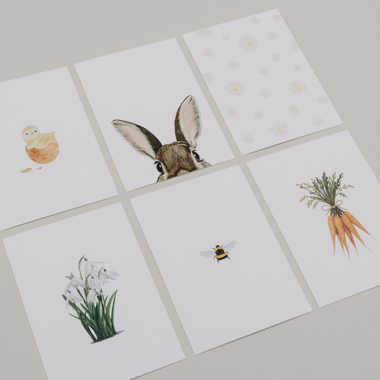 Aquarellkarten-Set mit Oster-Illustrationen wie Hase, Küken und Blumen.