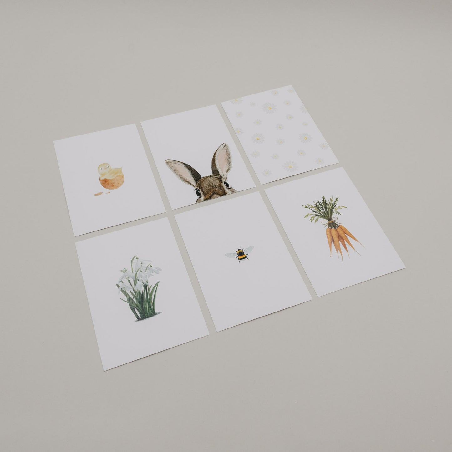 Set aus sechs Aquarellkarten mit Oster-Motiven auf hellem Hintergrund.