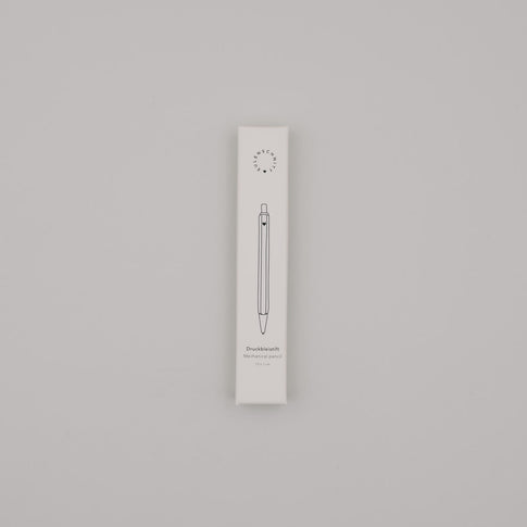 Verpackung des cremefarbenen Druckbleistifts mit minimalistischer Illustration